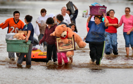 family moving their belongs in flood